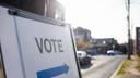 A sign directing voters to the entrance of a polling area.