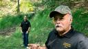 Dennis Parada, right, and his son Kem Parada stand at the site of the FBI's dig for Civil War-era gold in Dents Run, Pennsylvania.