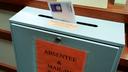 A ballot is deposited into a box at the county clerk's office in Erie. A newly approved resolution is meant to bar groups of people openly carrying firearms from gathering near polling places and drop boxes.