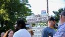 People stand in front of the Tioga borough office sign.