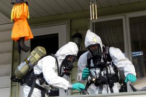 Members of the Pennsylvania State Police Clandestine Lab Response Team remove chemicals from the front porch of a home in Minersville in 2013.