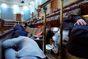 People shelter in the House gallery as protesters try to break into the House Chamber at the U.S. Capitol on Wednesday, Jan. 6, 2021, in Washington. (AP Photo/Andrew Harnik)